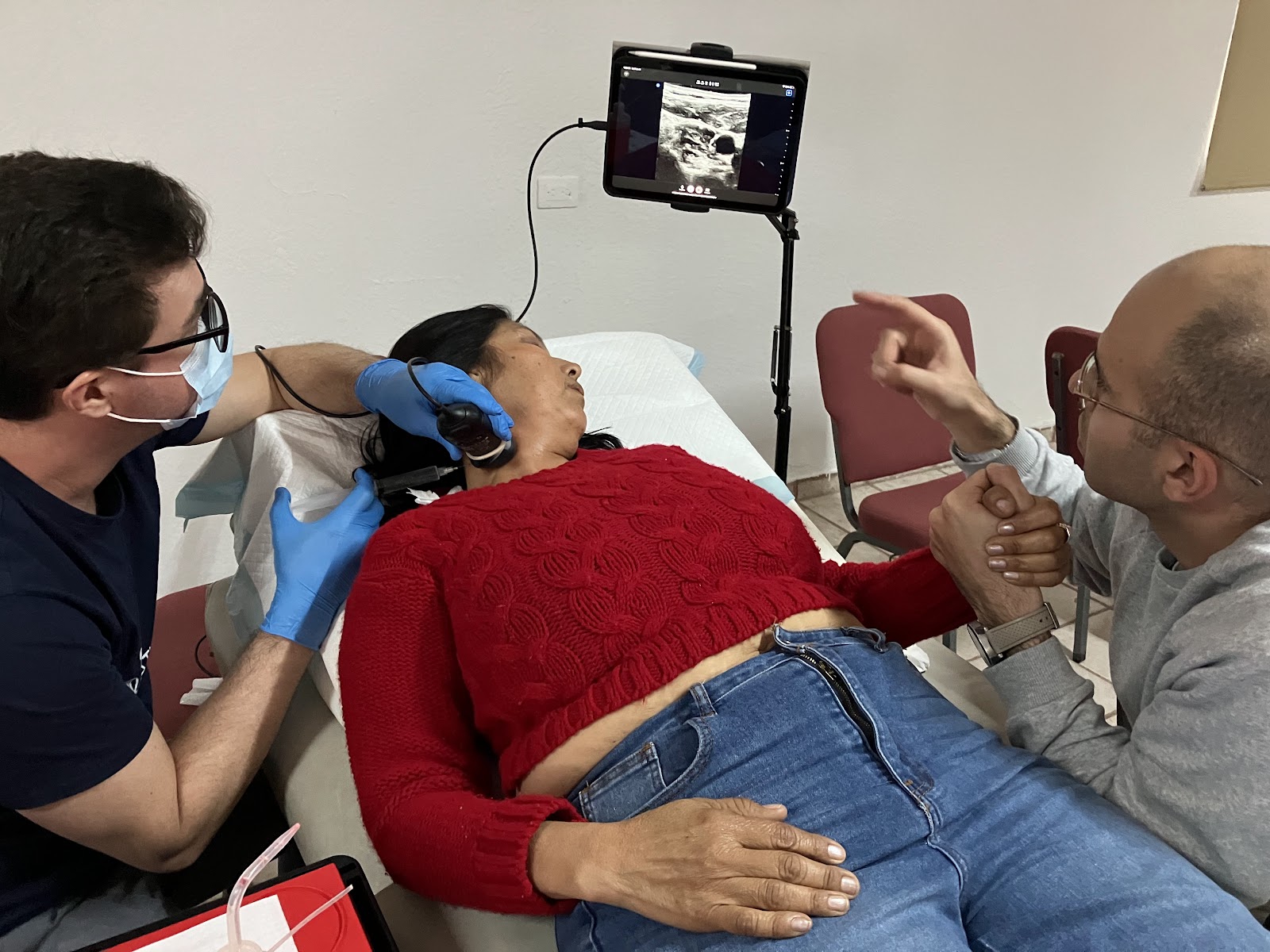 A volunteer learning ultrasound-guided regenerative injection techniques under clinical supervision